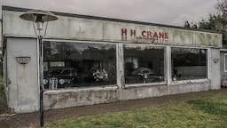 Abandoned vintage cars left to rot in an old show room