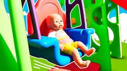 Baby Annabell doll plays with toys. Baby Born doll on a playground for kids. Pacifier for baby dolls