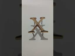 Letter X. Polished cast bronze letter. Cast bronze letters in a Trajan font. Prismatic.