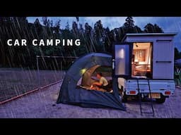 Car camping in a sudden downpour. DIY light truck camper