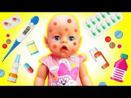 Baby Emily doll is ill! Kids pretend to play doctor for the baby born doll. Nursery toys for kids.