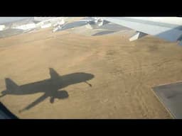 Plane landing with its shadow