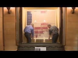 Hands on with History: MN Historical Society staff change out the rotunda’s battle flags