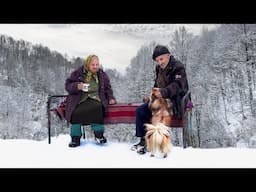 Happy old age of an elderly couple in a mountain village in winter far from civilization