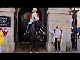 KING'S GUARD LOOKS CLOSELY AS ONE LADY TRIES TO TOUCH THE HORSE