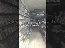 abandoned gamestop with stuff stacked to ceiling