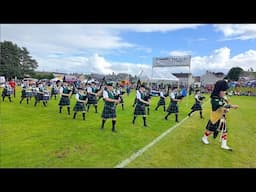 Huntly Pipe Band march out playing Cullen Bay during 2024 Dufftown Highland Games in Scotland