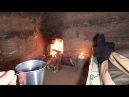 Warm and secret dugout provides warmth in the cold, cooking in a forest shelter