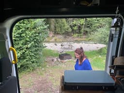 Van camping at a wild mountain creek - Beautiful Swiss nature, foothills of the Alps.