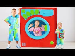 Oliver and Roma pretend play with toy washing machine