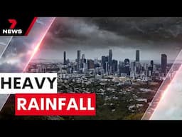 Rescue crews save man clinging to tree after Queensland hit by heavy rain | 7NEWS